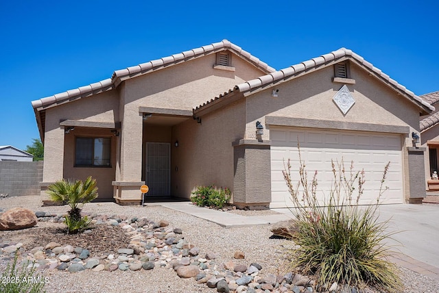 1102 N 5th St, Buckeye, AZ 85326 - view of front of house with a garage, stucco siding, and a tiled roof