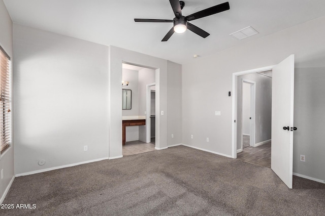 1102 N 5th St, Buckeye, AZ 85326 - unfurnished bedroom featuring carpet flooring, ensuite bath, and ceiling fan