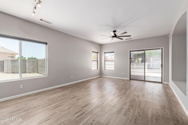 1102 N 5th St, Buckeye, AZ 85326 - spare room featuring ceiling fan, wood finished floors, and arched walkways