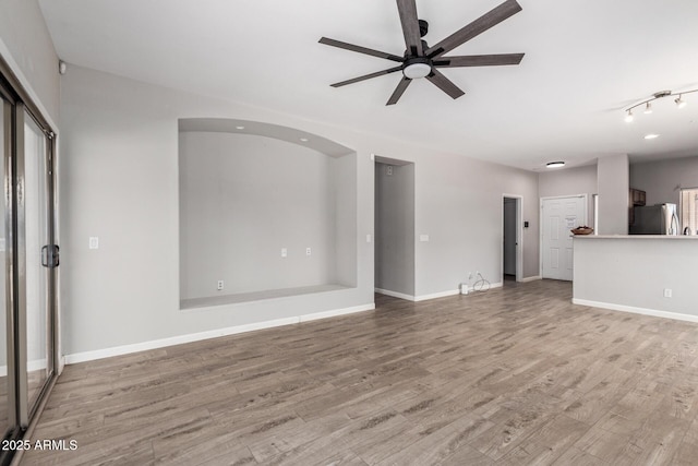 1102 N 5th St, Buckeye, AZ 85326 - unfurnished living room with ceiling fan and wood finished floors