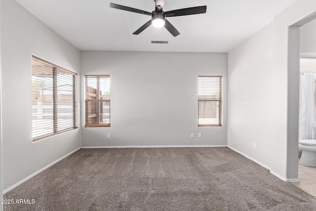 1102 N 5th St, Buckeye, AZ 85326 - carpeted empty room with ceiling fan and baseboards
