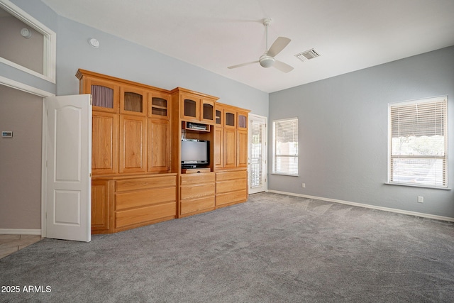 unfurnished living room with light carpet, ceiling fan, baseboards, and visible vents