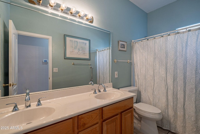 full bathroom with double vanity, a sink, and toilet
