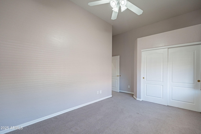 unfurnished bedroom featuring carpet floors, baseboards, a closet, and ceiling fan