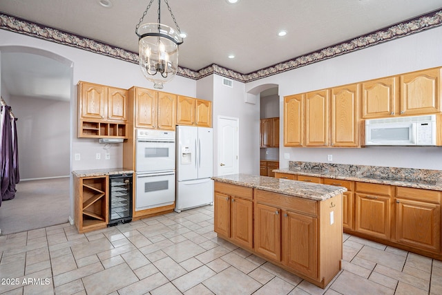 kitchen with wine cooler, open shelves, white appliances, and arched walkways