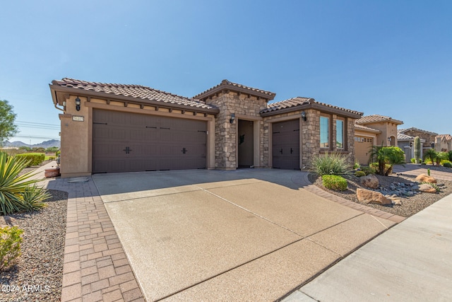 mediterranean / spanish-style house with a garage