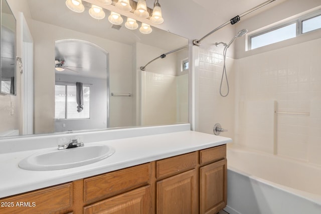 bathroom featuring vanity, shower / tub combination, and ceiling fan