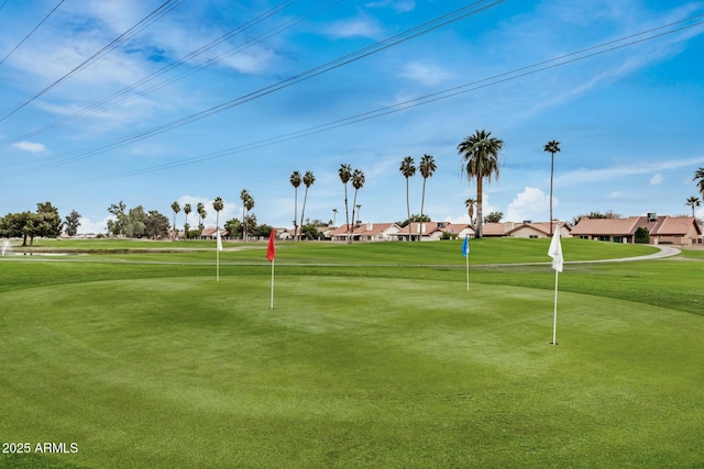 view of property's community with golf course view and a yard