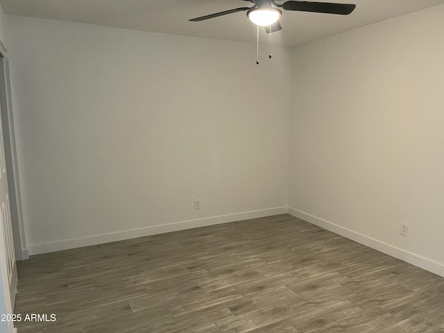spare room with wood finished floors, baseboards, and ceiling fan