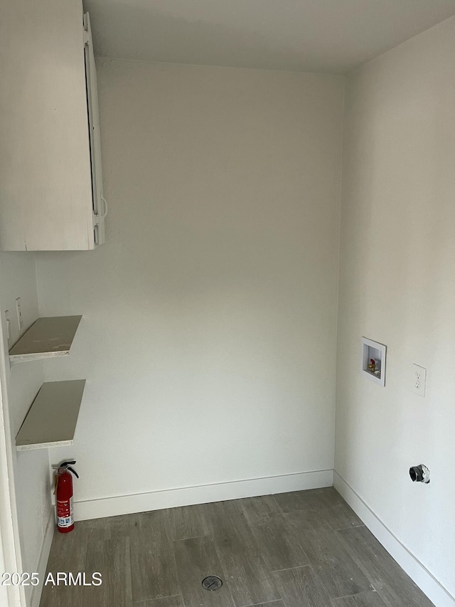 clothes washing area with baseboards, cabinet space, dark wood-style flooring, and hookup for a washing machine