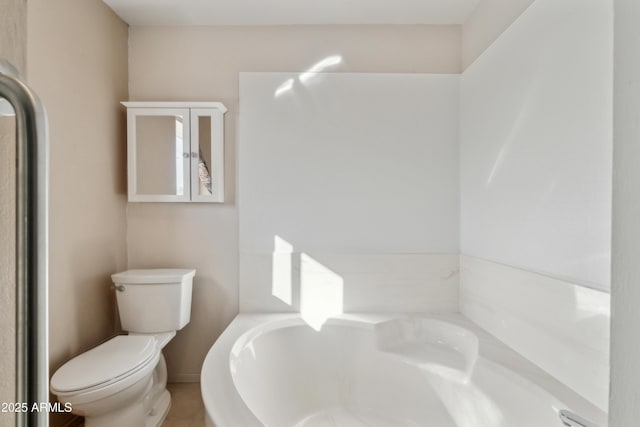 bathroom featuring a washtub and toilet