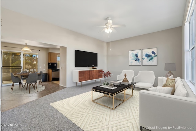 tiled living room with ceiling fan and plenty of natural light