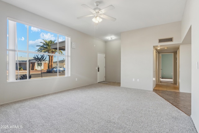 spare room featuring carpet flooring and ceiling fan