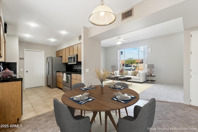 tiled dining space featuring ceiling fan