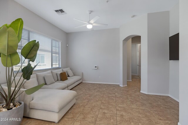 living room with ceiling fan and light tile patterned flooring