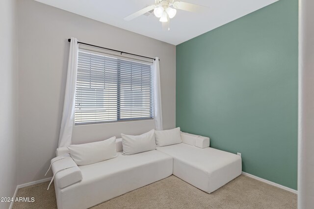 carpeted living room featuring ceiling fan