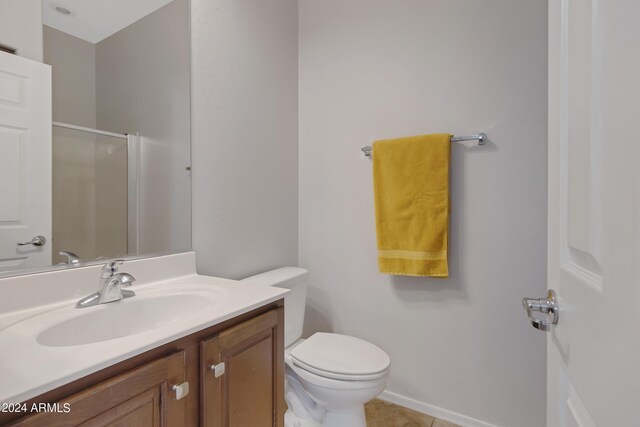 bathroom featuring vanity, tile patterned flooring, an enclosed shower, and toilet