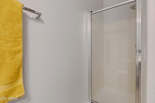 bathroom with a shower with shower door