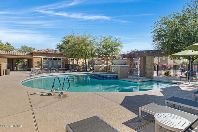 view of swimming pool featuring a pergola and a patio