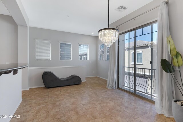 interior space featuring a notable chandelier and light tile patterned flooring