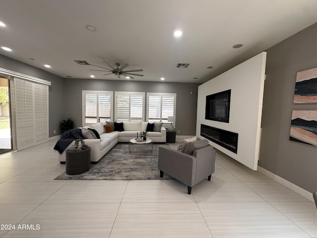 living room featuring light tile patterned floors and ceiling fan