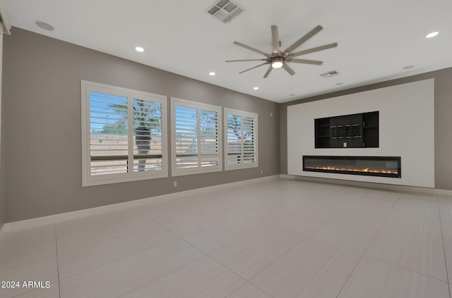 unfurnished living room with ceiling fan