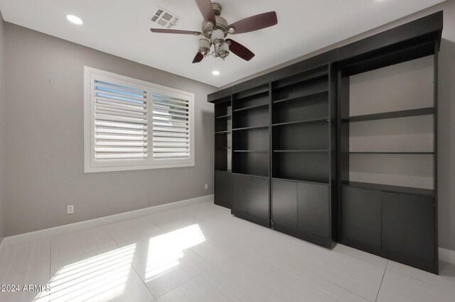 unfurnished bedroom with light tile patterned floors and ceiling fan