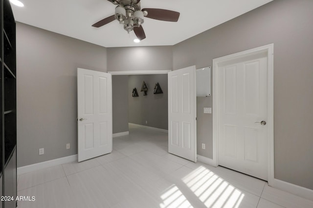 unfurnished bedroom featuring ceiling fan and light tile patterned floors