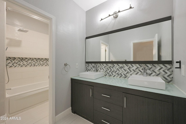 bathroom with tile patterned flooring,  shower combination, vanity, and decorative backsplash