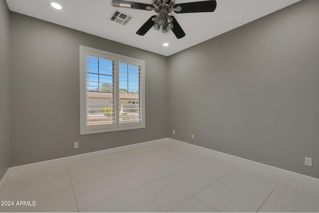 spare room with light tile patterned floors and ceiling fan