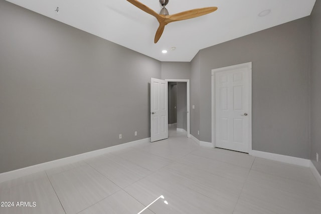 unfurnished bedroom with ceiling fan and light tile patterned flooring