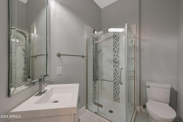 bathroom with vanity, a shower with shower door, and toilet