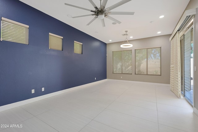 spare room with light tile patterned flooring and ceiling fan