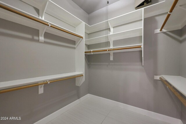 spacious closet with tile patterned floors