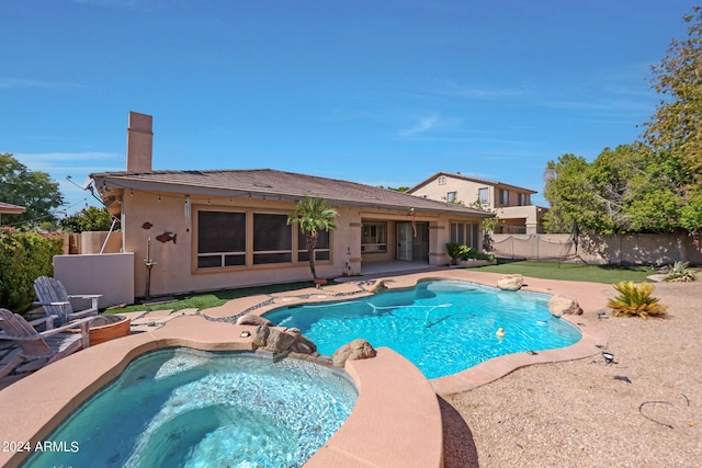 view of swimming pool featuring an in ground hot tub and a patio area