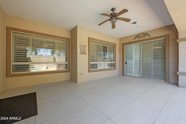 interior space featuring ceiling fan and a closet