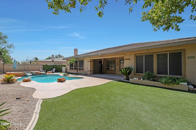 view of pool featuring a patio and a lawn