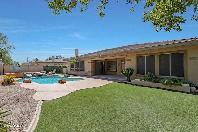 view of pool with a patio area and a lawn