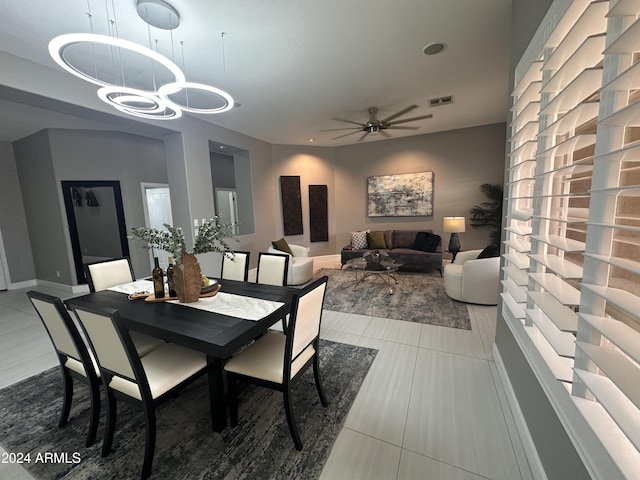 tiled dining area with ceiling fan