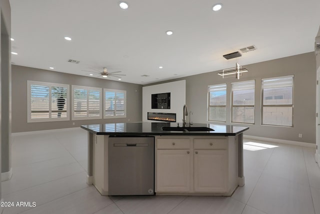 kitchen with dishwasher, sink, a center island with sink, and white cabinets