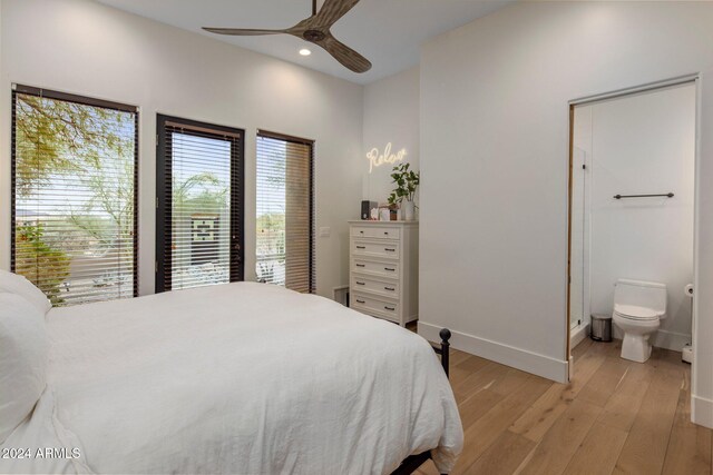 bedroom featuring access to outside, ensuite bath, light hardwood / wood-style flooring, and ceiling fan