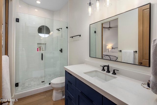 bathroom featuring hardwood / wood-style flooring, toilet, and walk in shower