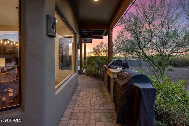 patio terrace at dusk with a grill