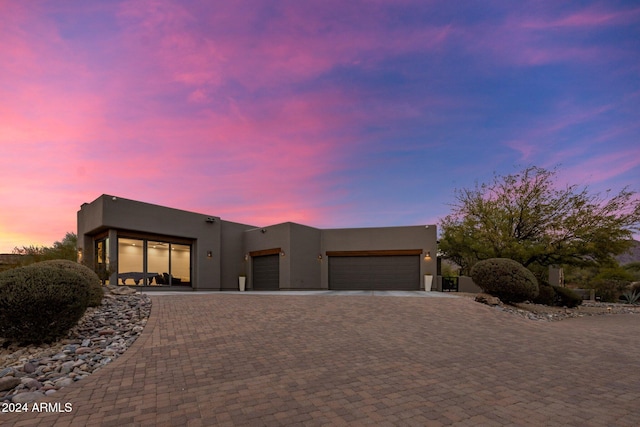 pueblo revival-style home with a garage