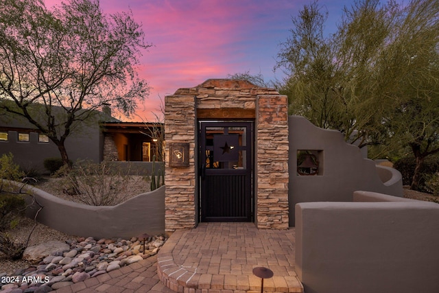 view of exterior entry at dusk