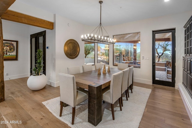 dining area featuring light hardwood / wood-style floors and a chandelier