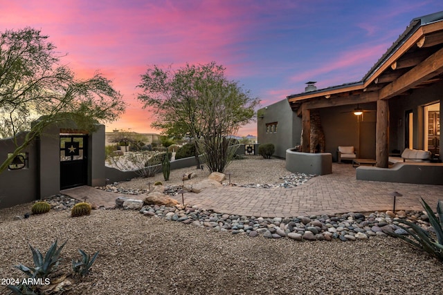 yard at dusk with a patio area