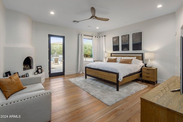 bedroom featuring access to outside, ceiling fan, and light hardwood / wood-style floors