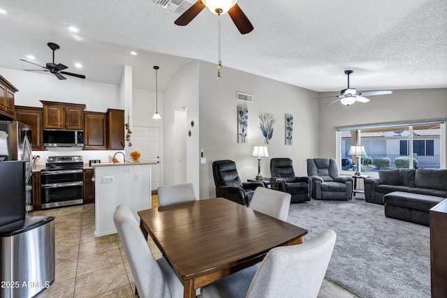 tiled dining area with ceiling fan, high vaulted ceiling, and a textured ceiling