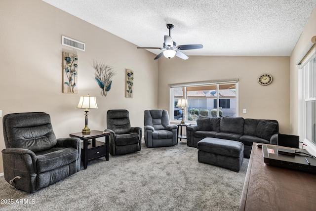 living room with carpet, a healthy amount of sunlight, lofted ceiling, and a textured ceiling